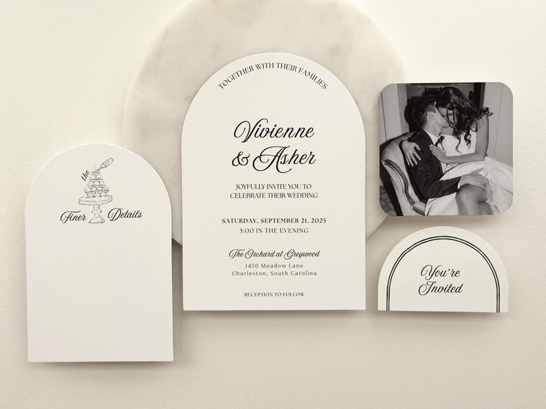 May include: A collection of wedding stationery, including an invitation with the names "Vivienne & Asher" and event details. Additional cards feature text like "Finer Details" and "You're Invited," along with a black and white photo.