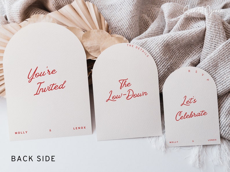 May include: Three white arched cards with red text. The first card says "You're Invited" with the names "Molly & Lenox" at the bottom. The second card says "The Low-Down" with "The Details" at the top. The third card says "Let's Celebrate" with "RSVP" at the top and "Molly & Lenox" at the bottom.
