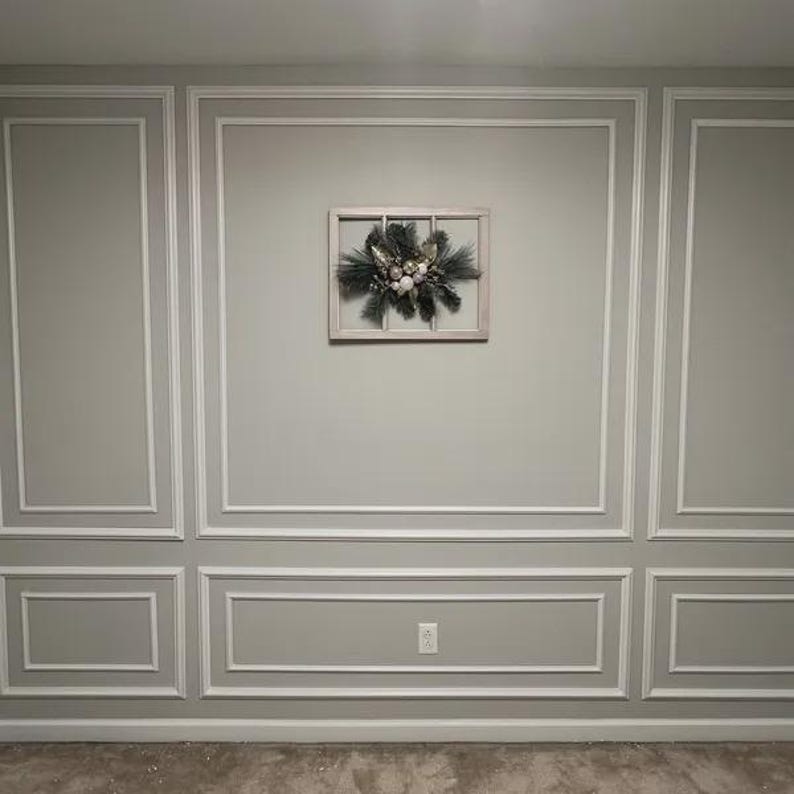 May include: A rectangular wooden window frame wall decoration featuring a central arrangement of dark green pine needles, silver-toned foliage, and a cluster of small, round, white and silver ornaments mounted on the center of the frame.