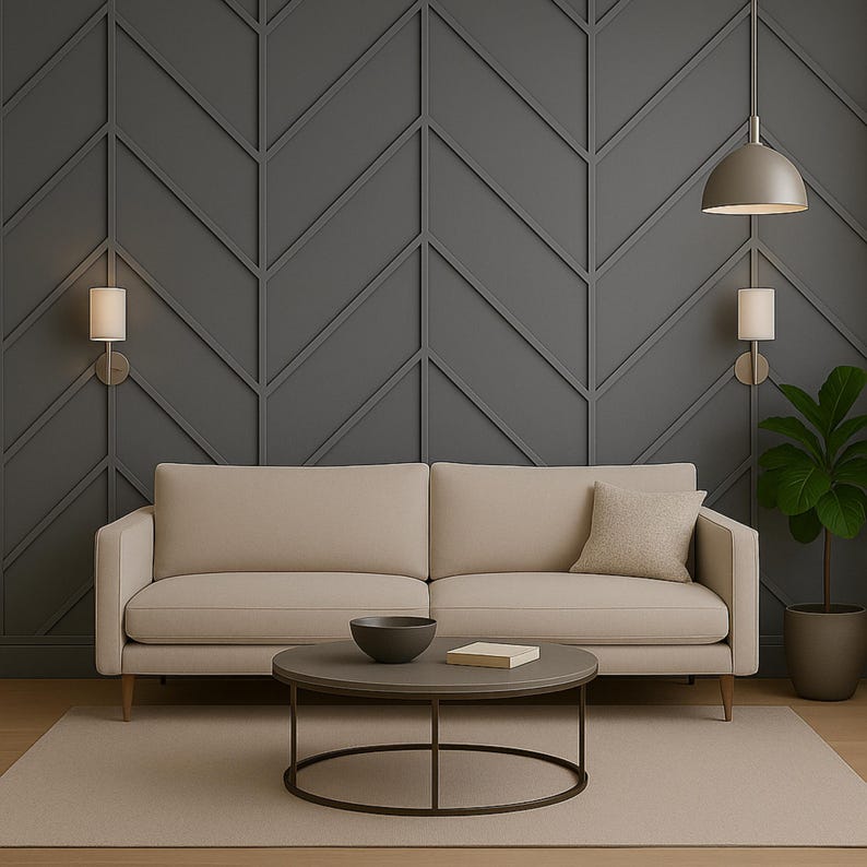 May include: A beige sofa with a matching throw pillow sits in front of a dark gray accent wall with a geometric pattern. A round coffee table with a dark bowl and book is in front of the sofa. A potted plant and two wall sconces complete the room.