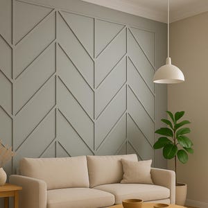 May include: A modern living room featuring a light gray accent wall with a geometric pattern. A beige sofa with matching pillows sits in front of the wall. A white pendant light hangs from the ceiling, and a potted plant adds a touch of greenery.