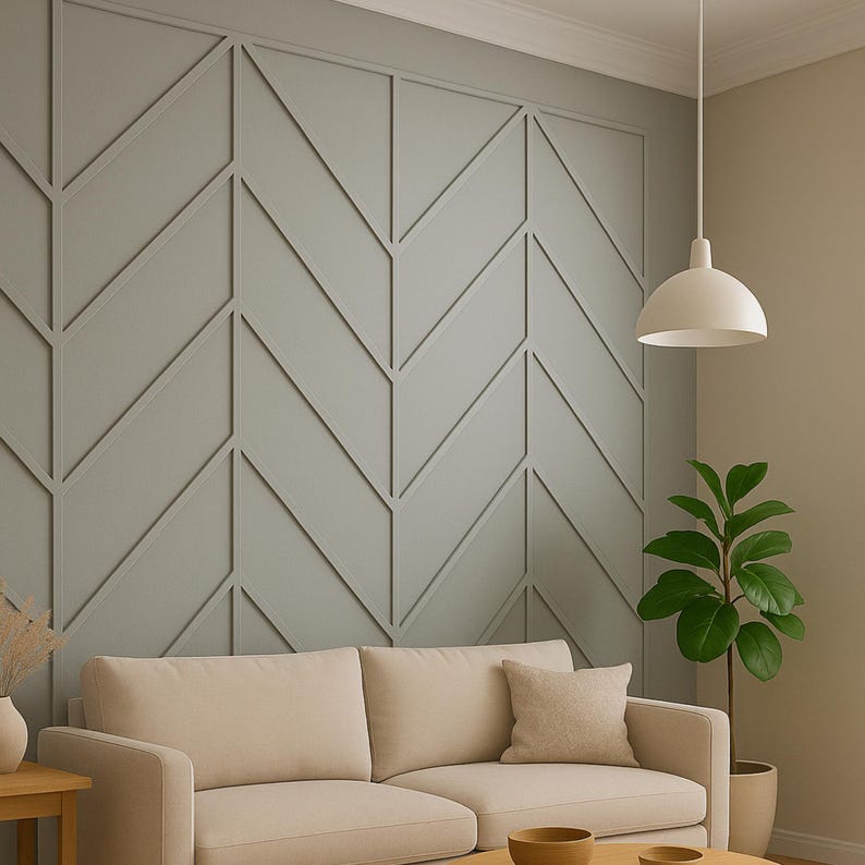 May include: A modern living room featuring a light gray accent wall with a geometric pattern. A beige sofa with matching pillows sits in front of the wall. A white pendant light hangs from the ceiling, and a potted plant adds a touch of greenery.