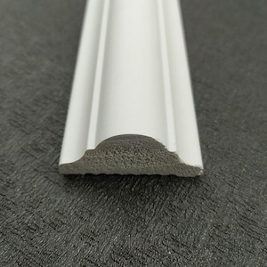 May include: White decorative molding with a rounded edge. The molding is made of a lightweight material and has a smooth finish.