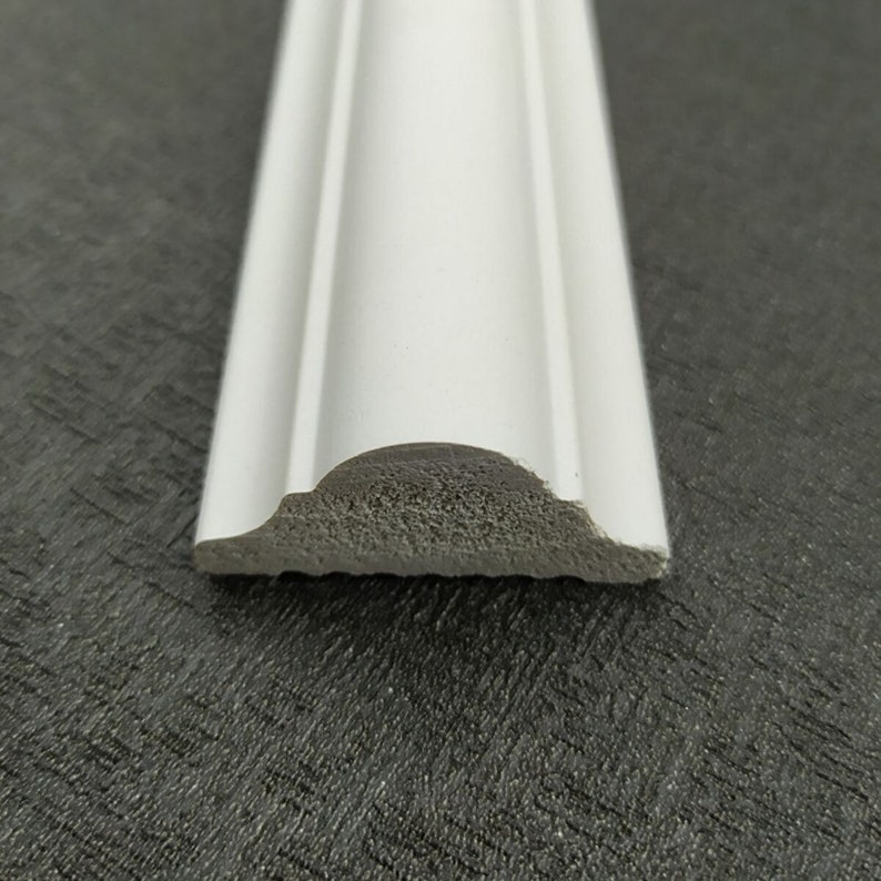 May include: White decorative molding with a rounded edge. The molding is made of a lightweight material and has a smooth finish.
