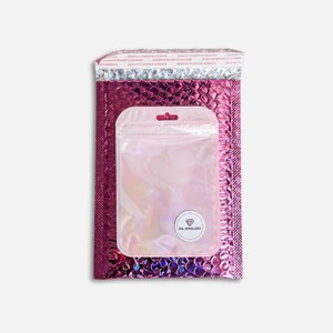 May include: A pink bubble mailer with a clear iridescent zip-top bag inside. The mailer has a metallic silver top and a peel-and-seal strip. The bag has a small white sticker with the text "EVA JEWELLERY".