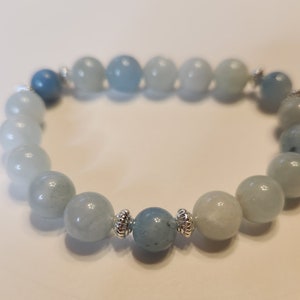 Aquamarine Crystal Stretch Bracelet with Sterling Silver Accents. Easy to personalize with a removable charm!