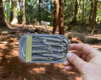 iron-on 5” x 3” embroidered “Sardine Can” patch.