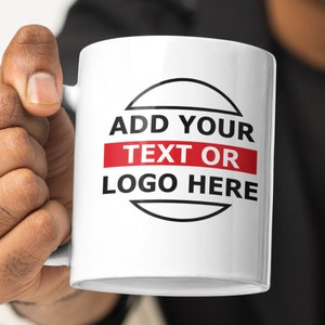 May include: White ceramic mug with a black circle and the text "ADD YOUR TEXT OR LOGO HERE" in black and red.