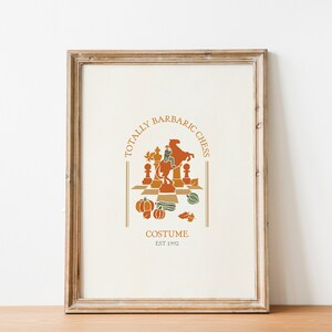 May include: A framed print with a vintage-style illustration of a chessboard with autumnal colors. The text reads "Totally Barbaric Chess Costume Est 1992".