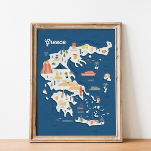 May include: Framed map of Greece with a blue background and a light wood frame. The map features illustrations of landmarks and icons, including a volcano, boat, and palm trees. The word "Greece" is written in a cursive font.