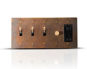 Toggle, dimmer switch & outlet in solid aged brass plate