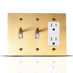Toggle light switch and outlet combo brass wall plate