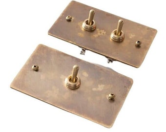 Toggle switch with aged brass wall plate