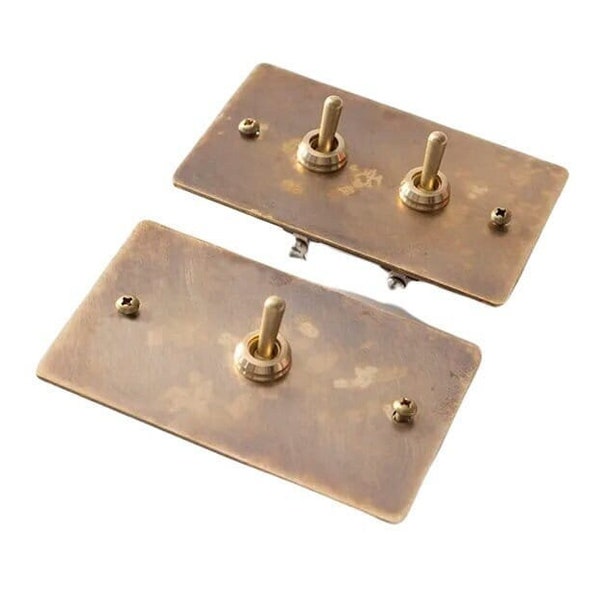 Toggle switch with aged brass wall plate