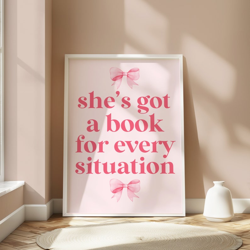 Framed pink wall art featuring the quote She’s Got a Book for Every Situation with feminine bow accents, perfect for book lovers, reading nooks, and cozy decor. Book Merch, Harry Styles Merch, Bookish Prints, Coquette Decor, Aestethic wall art