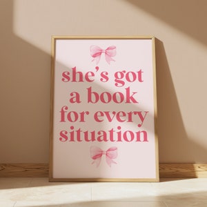 pink wall art featuring the quote She’s Got a Book for Every Situation with feminine bow accents, perfect for book lovers, reading nooks, and cozy decor. Book Merch, Harry Styles Merch, Bookish Prints, Coquette Decor,Aestethic wall art
