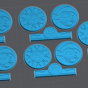 May include: Ten blue plastic tokens with different designs. Each token has a circular shape with a raised design. The designs include a sun, a star, and a swirl.