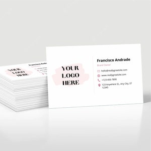 May include: A white business card with a pink brushstroke design and the text "YOUR LOGO HERE". The card includes the name "Francisco Andrade", the title "Brand Owner", and contact information including an email address, website, phone number, and address.