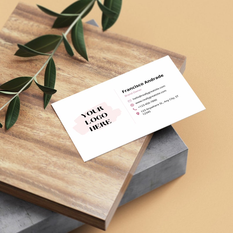 May include: White business card with a pink watercolor splatter design. The text "YOUR LOGO HERE" is in black text. The card includes contact information for Francisco Andrade, Brand Owner, including an email address, website, phone number, and address.