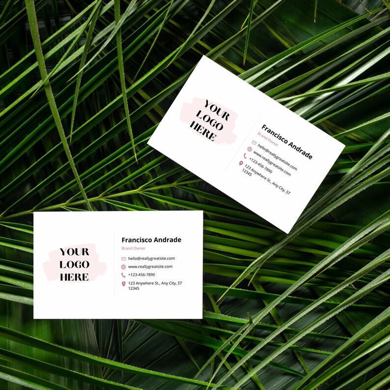 May include: Two white business cards with a pink logo placeholder that says "YOUR LOGO HERE". The text on the cards reads "Francisco Andrade", "Brand Owner", "hello@reallygreatsite.com", "www.reallygreatsite.com", "+123-456-7890", "123 Anywhere St, Any City, ST 12345".