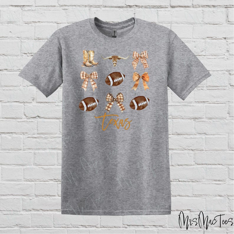 May include: Gray t-shirt with a design featuring a football, a cowboy boot, a bow, and the word "Texas".