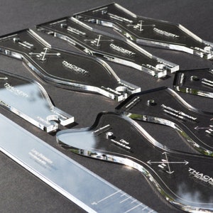 May include: A set of clear acrylic bow tie templates for crafting. The templates are labeled with different bow tie styles, including "Traditional Diamond", "Long & Narrow", and "Classic".