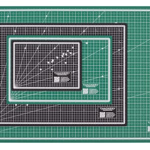 May include: Three self-healing cutting mats in different sizes. The mats are green with a grid pattern and black borders. The mats are labeled "THACKERY" in white text.