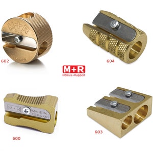 May include: Four gold metal pencil sharpeners with different designs. The sharpeners are labeled with the numbers 600, 602, 603, and 604. The sharpeners are made by M+R Mobius+Ruppert.