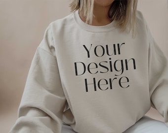 May include: A beige sweatshirt with the text "Your Design Here" printed on the front.