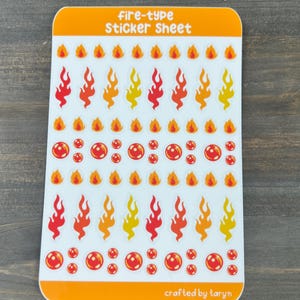 May include: A sticker sheet with a white background and orange border. The sheet features a variety of fire-themed stickers, including flames in different colors and red orbs. The text "fire-type Sticker Sheet" is printed at the top of the sheet, and the text "crafted by taryn" is printed at the bottom.