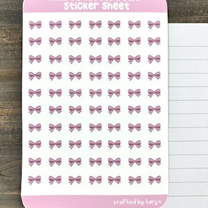 May include: A sticker sheet with 64 pink mini bows. The sheet is pink and has the text "mini coquette bows sticker sheet" at the top and "crafted by taryn" at the bottom.
