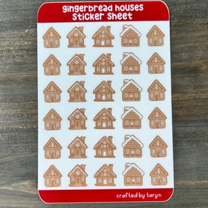 May include: A sticker sheet with a red border featuring multiple gingerbread house stickers. The stickers are brown with white accents and various decorative details. The text "gingerbread houses Sticker Sheet" is at the top.
