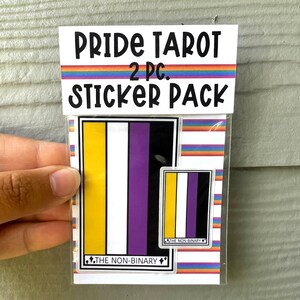 May include: A clear plastic package containing a Pride Tarot sticker pack. The pack includes two stickers with the non-binary pride flag design. The package has the text "PRIDE TAROT 2 PC. STICKER PACK" in black font with a rainbow stripe.