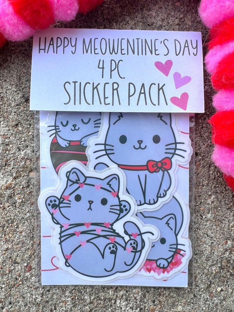 May include: A sticker pack with four cute cat illustrations. The stickers feature cats with hearts and the text "Happy Meowentine's Day 4 PC Sticker Pack".