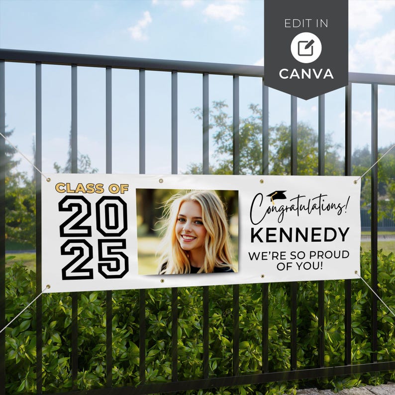 May include: White banner with the text "CLASS OF 2025" and "Congratulations! KENNEDY WE'RE SO PROUD OF YOU!" in black. A photo of a smiling young woman is in the center. The banner is hanging on a black fence.