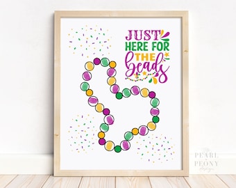 May include: A printable sign with the text "Just here for the beads" in purple and green lettering. The sign features a purple, green, and gold beaded necklace and confetti in the background.