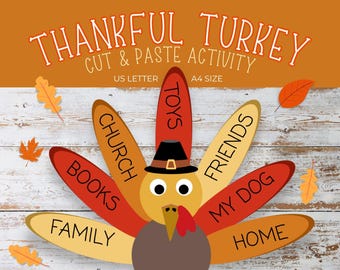 May include: A Thanksgiving-themed printable activity for kids. A cartoon turkey with a hat and feathers labeled with words like "toys", "church", "books", "family", "friends", "my dog", and "home". The text "Thankful Turkey Cut & Paste Activity" is at the top of the image.
