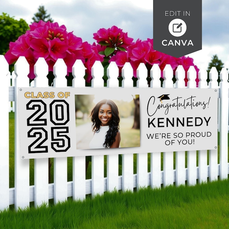 May include: A white banner with the text "CLASS OF 2025" and "Congratulations! KENNEDY WE'RE SO PROUD OF YOU!" is displayed on a white picket fence. A photo of a smiling woman is in the center. Pink flowers are above the fence.