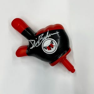 May include: A red and black foam hand with a black and white logo that says "BB" and a signature that says "Dave Bautista".