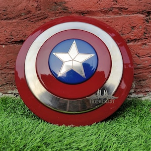 May include: A red, white and blue Captain America shield replica. The shield has a silver metal rim and a blue centre with a white star.