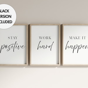 May include: Three framed art prints with motivational quotes. Each print has a white background with black text. The first says "Stay positive", the second says "Work hard", and the third says "Make it happen". The frames are light brown.