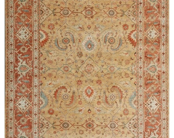 May include: A beige rug with a detailed floral pattern in shades of red, blue, and green. The rug has a border with a repeating geometric design.