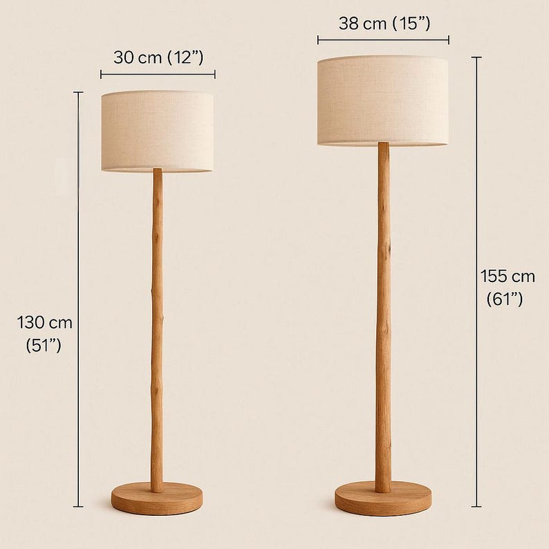 May include: Two wooden floor lamps. The smaller lamp is 51 inches tall with a 12-inch lampshade. The larger lamp is 61 inches tall with a 15-inch lampshade. Both lamps have a natural wood finish and beige fabric shades.