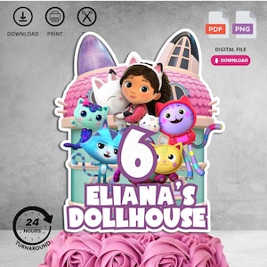 May include: A cake topper featuring characters from "Gabby's Dollhouse" with the number 6. The design includes Gabby, various cat characters, and the text "Eliana's Dollhouse". The topper is set against a pink and teal background.