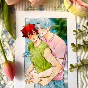 May include: A rectangular art print featuring a digital illustration of two anime-style characters embracing. One character has short red hair and a green sleeveless shirt, while the other has light blue hair and a pink t-shirt. Text reads art by moonbk9.