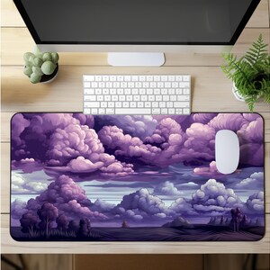 May include: Purple and white cloud-shaped mouse pad with a purple and white cloud design. The mouse pad is on a wooden surface with a computer keyboard and a potted plant.