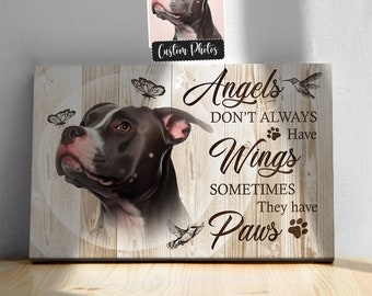 May include: A canvas print with a woodgrain background featuring a black and white dog with the text "Angels don't always have wings, sometimes they have paws".