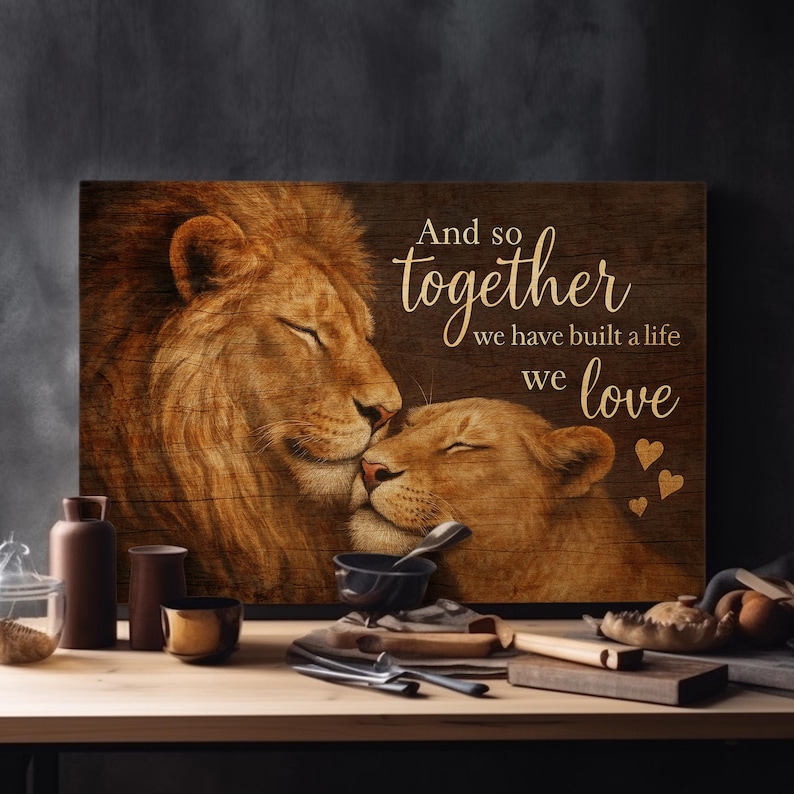 May include: A wood-grain background with a painting of two lions cuddling. The text reads "And so together we have built a life we love".