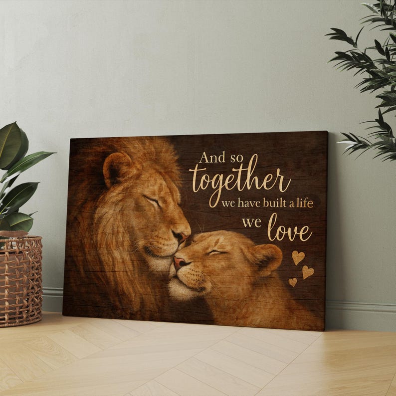 May include: A wood-grain background with a lion and lioness cuddling. The text reads "And so together we have built a life we love" with small hearts around the text.