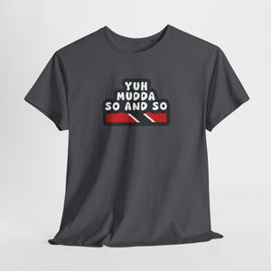 May include: Dark gray t-shirt with the text "Yuh Mudda So and So" in white, with a red, black, and white graphic below. The shirt is a short-sleeved crew neck.